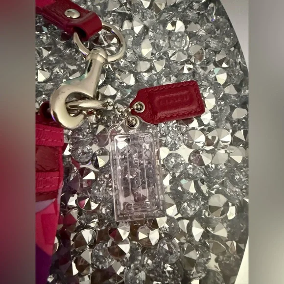 Coach Poppy Wristlet featuring a pink and purple geometric pattern. - Picture 8 of 9